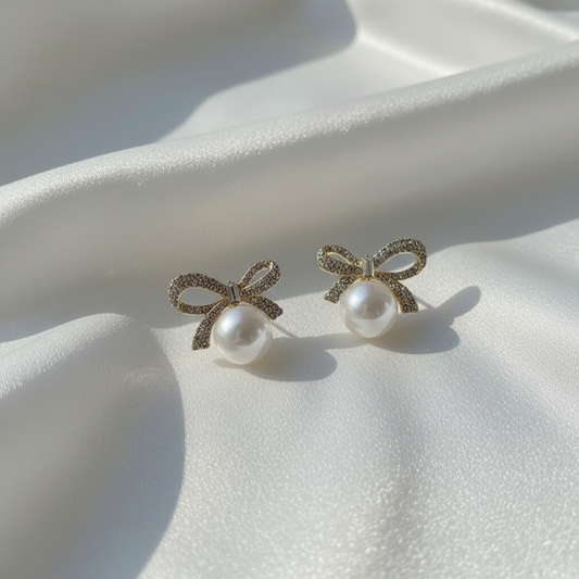 Pearl bow earrings on white silk