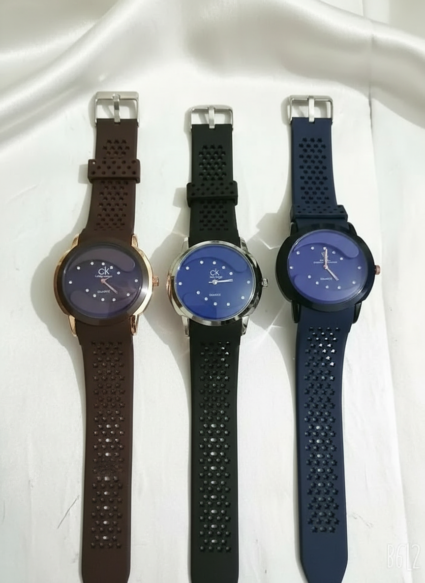 Three CK watches on white silk